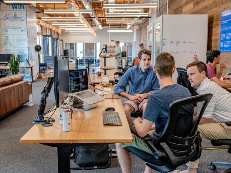 How to Choose a Digital Marketing Agency: 12 Questions to Ask Business owner meeting a digital marketing agency team to review a proposal